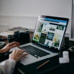 Home A creative workspace featuring a laptop displaying a gallery of images, ideal for digital nomads and remote work.